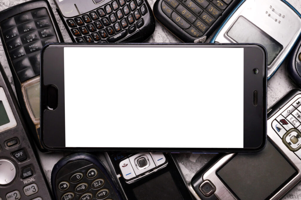 A smartphone on pile of obsoleted cellphones.